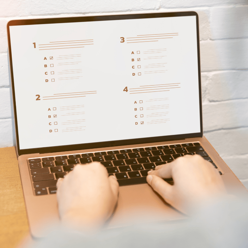 Person taking an online business assessment quiz on a laptop to identify gaps in restoration claims processes and cash flow